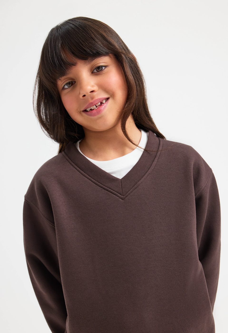 Uneek UC206 childrens V neck sweatshirt modelled